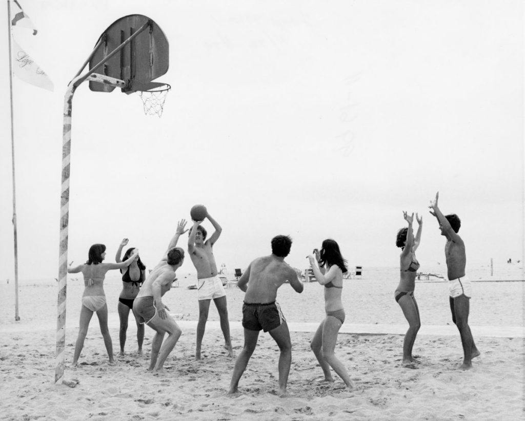 black and white photo of "Young people playing korfball on the beach at the Lago Mar resort - Fort Lauderdale, Florida" circa 1972